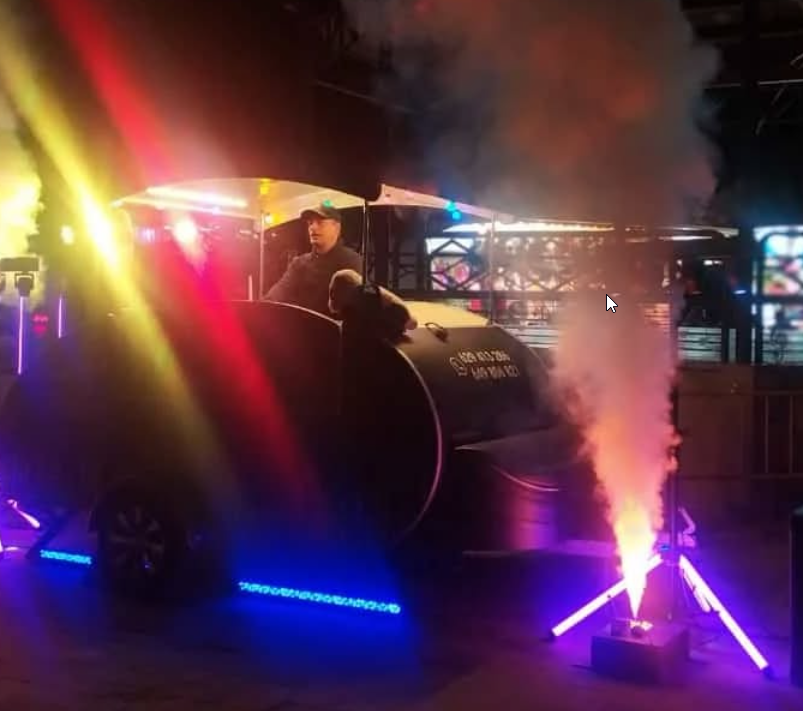 A lively party with a DJ and dancing crowd.